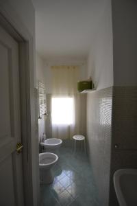 a bathroom with two sinks and two toilets at Casa RoSiLù in Monopoli +16 photos