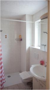 y baño con lavabo, ducha y aseo. en Bed and Breakfast Prilly-Lausanne en Prilly