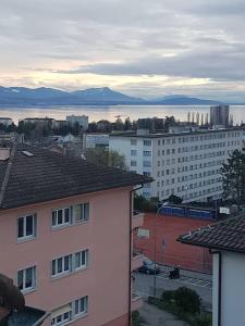 a view of a city with buildings and the water at Bed and Breakfast Prilly-Lausanne in Prilly