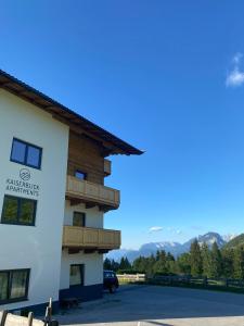 a building with a view of the mountains at Kaiserblick Apartments in Oberau