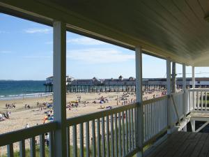 a view of a beach from the porch of a house at Copley LaReine Motel in Old Orchard Beach