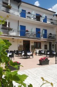 a view of the courtyard of a hotel with tables and chairs at Hotel Luisa in Brenzone sul Garda
