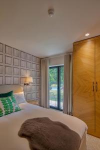a bedroom with a large bed and a sliding glass door at Casa do Rio in Mondim de Basto +157 photos