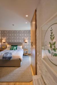 a bedroom with a bed and a large window at Casa do Rio in Mondim de Basto