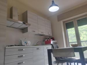 a kitchen with white cabinets and a table with chairs at Da nonna Antonietta in Ferrandina