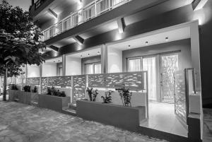 a lobby with a row of potted plants at Mr & Mrs K Lofts in Potos