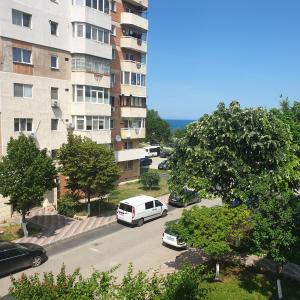 a white van parked in a parking lot next to a building at Rozelor in Mangalia