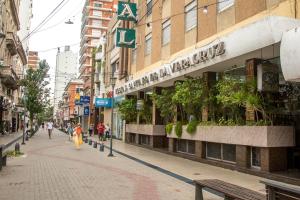 a street in a city with people walking down the street at Hostal Santa Fe De La Veracruz in Santa Fe