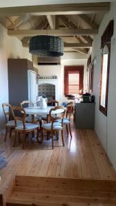 a kitchen and dining room with a table and chairs at FEEL LIKE HOME IN LESVOS in Mytilene