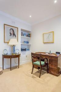 a room with a desk and a chair and a dresser at Stylish 3BR house with patio, short walk to Regents Park & Harley Street in London
