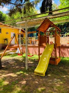 a playground with a slide and a play structure at Holiday Village Interpark in Kranevo
