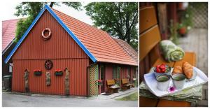 une grange rouge avec une plaque de nourriture devant elle dans l'établissement 3 kambarių butas ir kotedžas, à Nido