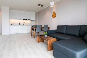 a living room with a couch and a table at Ö Seaside Suites & SPA in Kuressaare
