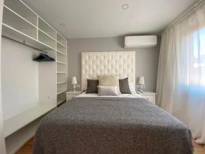 A bed or beds in a room at Besos Beach Gem II By MyRentalHost