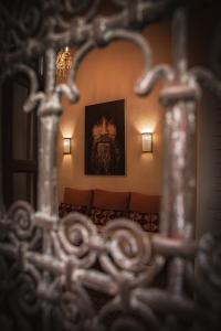 a mirror in a room with a portrait of a man at Dar Shâan in Rabat