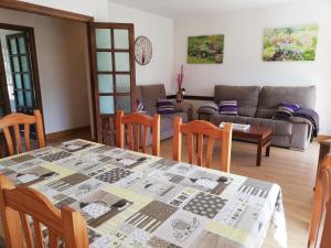 a living room with a table and a couch at Apartamento Peñalabra in Potes