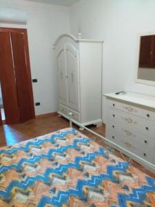 a bedroom with a bed and a dresser and a drawer at Agriturismo Spinaruccoli in Cicerale