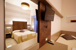 A bed or beds in a room at Hotel Fernanda