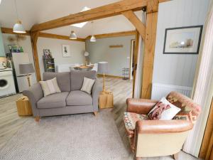 a living room with a couch and two chairs at Goose Lodge in Shipston on Stour