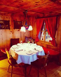 a dining room with a white table and chairs at Gasthof Auerhahn in Lech am Arlberg