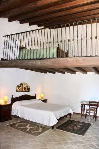 a bedroom with a large bed and a staircase at Agriturismo Sant'Agata in Piana degli Albanesi