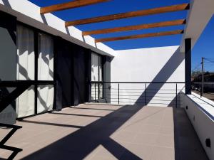 a balcony of a house with a wooden roof at BIG POSADAS in Concepción del Uruguay