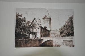 an old picture of a building next to a bridge at D´r Rechenmacher in Michelfeld