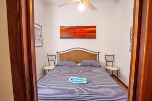 A bed or beds in a room at SeaBreeze Baia Verde