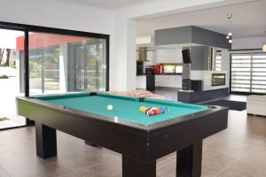 a living room with a pool table in it at Villa Paraiso in Troia