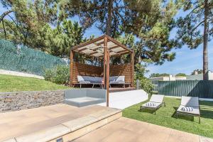 a gazebo with two chairs and a bench at Villa Paraiso in Troia