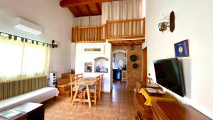 a living room with a couch and a table at CAN DAMIA 1 in Cala Saona