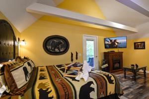 a bedroom with two beds and a flat screen tv at Mountain Romance in Gatlinburg
