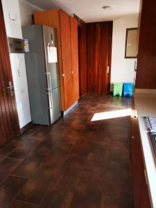 a kitchen with a refrigerator and a tile floor at Casa Compartida Weyler in Santa Cruz de Tenerife