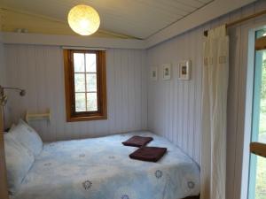a bedroom with a bed with two towels on it at Devon Eco Lodges in Winkleigh