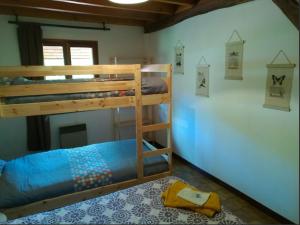 a bedroom with two bunk beds in a room at La Bergerie Crenantine in Crenans