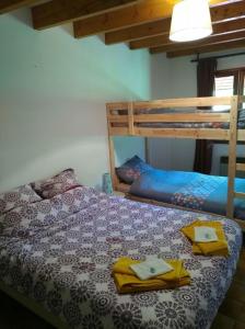 a bedroom with a bed with two bunk beds at La Bergerie Crenantine in Crenans