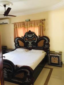 an ornate bed in a bedroom with a window at PARADISE ESTATE PEACEFUL QUITE COMFORTABLE SECURED GATED WIFI pOOL in Old Yundum