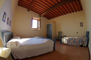 A bed or beds in a room at Agriturismo Il Palazzo