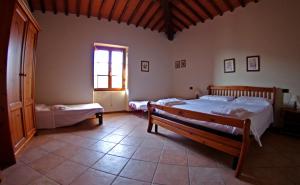 A bed or beds in a room at Agriturismo Il Palazzo