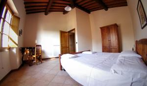 A bed or beds in a room at Agriturismo Il Palazzo