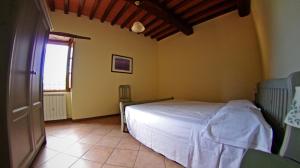 A bed or beds in a room at Agriturismo Il Palazzo