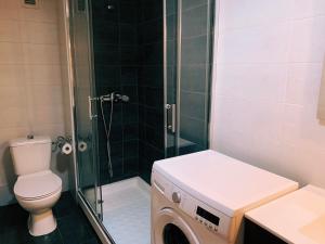 a bathroom with a shower and a washing machine at Ayuntamiento Silence in Valencia +62 photos