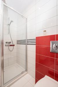 a bathroom with a shower with a glass door at Pod Żaglami in Rowy