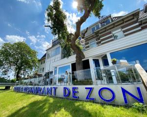 a sign in front of a building at De Zon Hotel & Restaurant by Flow in Ommen