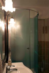 a bathroom with a sink and a glass shower at Apartament Mountain Life in Buşteni +42 photos