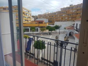 a balcony with a view of a city with buildings at Hotel Torremolinos Centro in Torremolinos