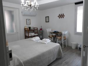 a bedroom with a bed and a table and a chandelier at Come una volta in Monte Isola