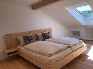 a large bed in a room with a window at Seehof Apartments in Walchensee