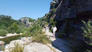 two people walking on a path next to a river at La Cle Des Champs in Montréal