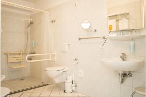 a bathroom with a toilet and a sink at Hotel & Restaurant Am Alten Rhin in Neuruppin +46 photos
